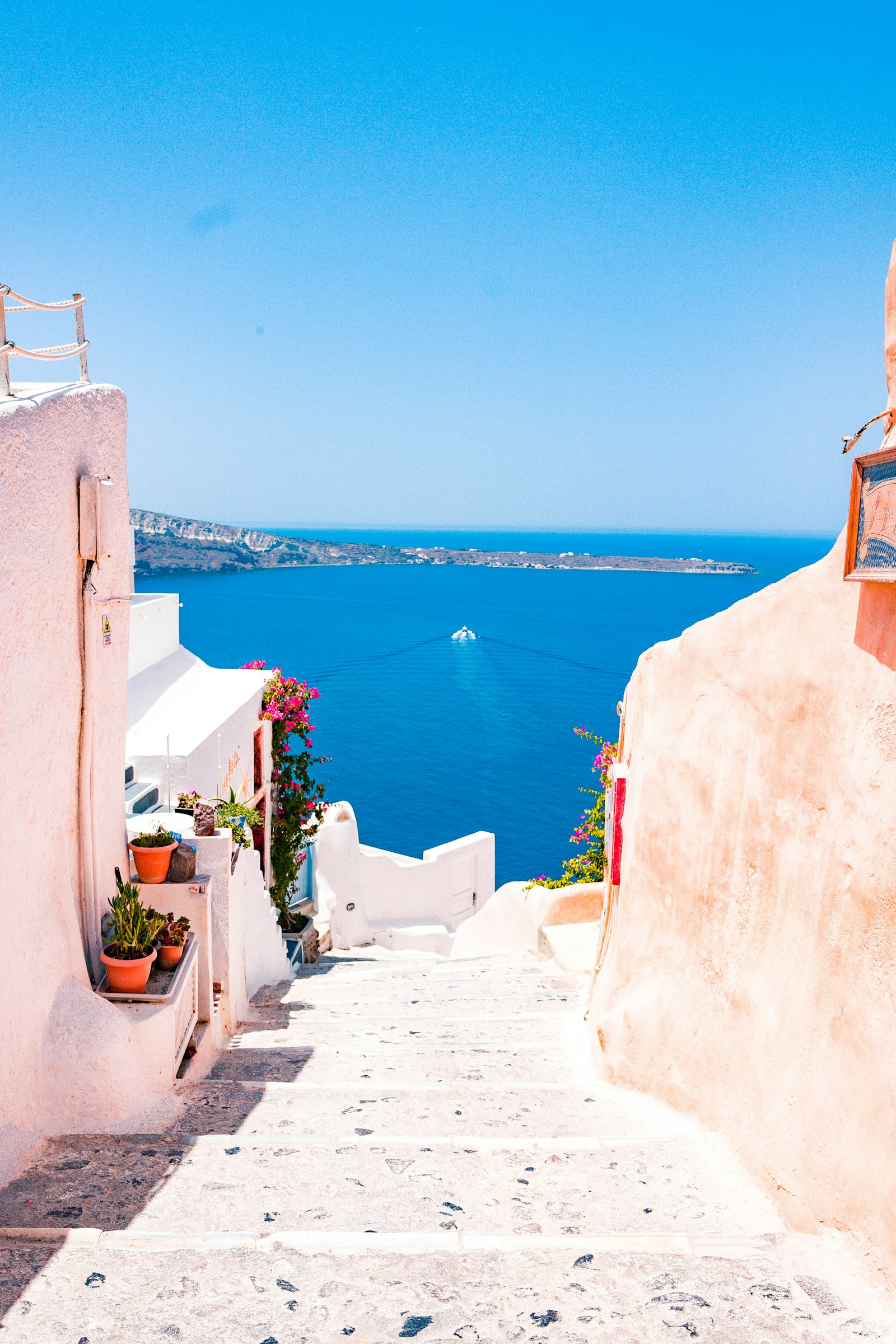 Whitewashed Greek coastal village over the Aegean sea